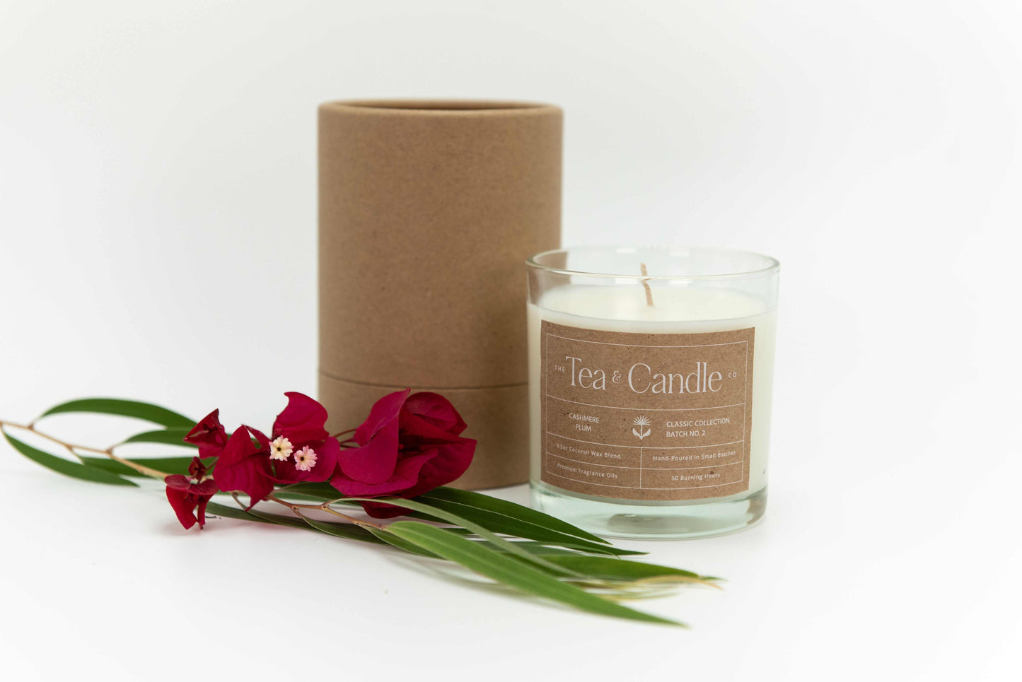 Cashmere Plum Coconut Wax Candle with floral decoration, 7 oz natural coconut wax blend, in glass jar packaging.