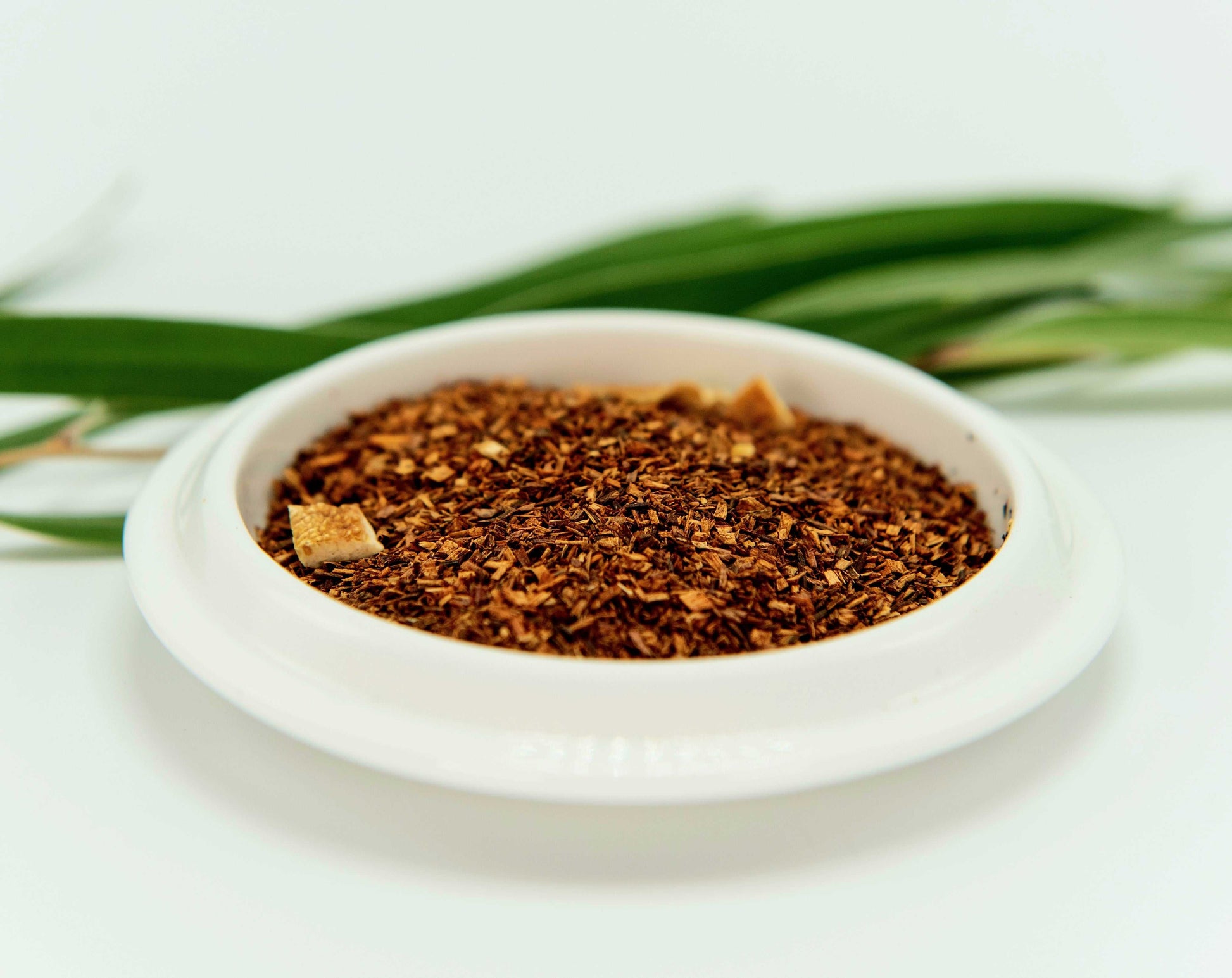 Blood Orange Rooibos Tea in white dish with orange zest.